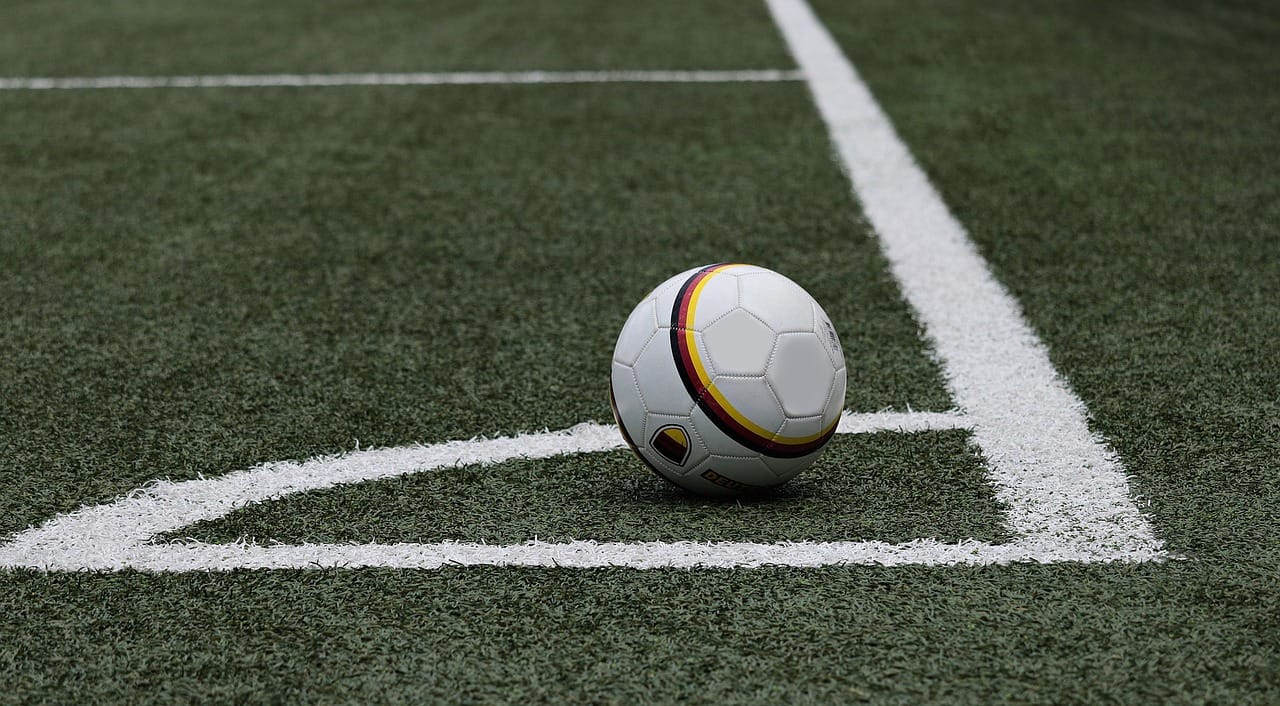 A soccer ball in corner of field